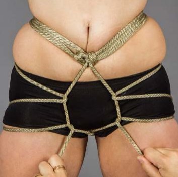 Pull ends underneath center front crotch rope. 
